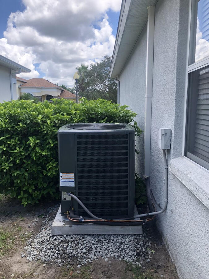 Reliability meets performance with this residential AC condenser installation. Mounted on a reinforced, level pad for optimal drainage and airflow, this Goodman cooling system is built to withstand the humidity and heat of the local climate. Trust our HVAC Reliability meets performance with this residential AC condenser installation. Mounted on a reinforced, level pad for optimal drainage and airflow, this Goodman cooling system is built to withstand the humidity and heat of the local climate. Trust our HVAC