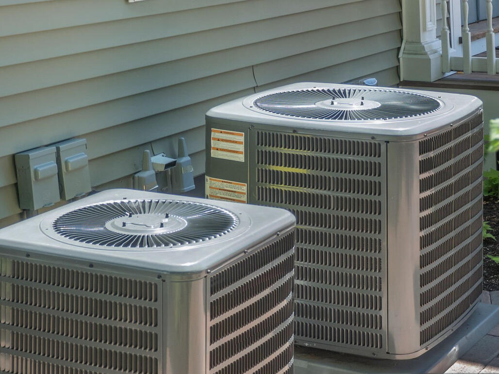 Boost your home's efficiency with a professional dual-system AC installation. This setup features two high-performance residential AC condenser units mounted on precision-leveled concrete pads to ensure maximum airflow and drainage.